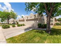 Attractive single-story home featuring a two-car garage, desert landscaping, and a well-maintained lawn at 5445 E Mckellips Rd # 48, Mesa, AZ 85215