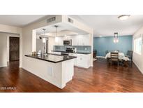 Modern kitchen featuring dark countertops and stainless steel appliances at 5926 S Newberry Rd, Tempe, AZ 85283