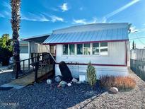 Charming single-story home with a well-maintained exterior and beautiful landscaping with gravel at 5933 E Main St # 114, Mesa, AZ 85206