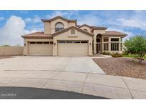 Beautiful two-story home featuring a three-car garage, desert landscaping, and a tile roof at 9825 E Gary St, Mesa, AZ 85207