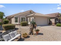 Charming single-story home featuring a desert-landscaped yard, bench, and neutral-tone exterior at 1241 E Elm Rd, San Tan Valley, AZ 85140