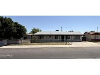 Charming single-story home with a well-maintained front yard and black chain-link fence at 1723 W Cheryl Dr, Phoenix, AZ 85021