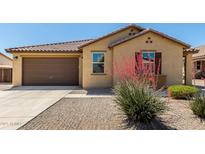 Charming single-story home with a well-manicured desert landscape and a two car garage at 18658 N Tanners Way, Maricopa, AZ 85138