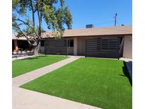 Charming home featuring a well-manicured front yard with lush green grass and a lovely walkway at 1954 E Nielson Ave, Mesa, AZ 85204