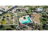 Aerial view of community pool, park and playground with palm trees and green spaces at 22876 E Via Del Sol --, Queen Creek, AZ 85142