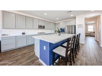 Stylish kitchen featuring a spacious island, ample counter space, and modern appliances at 25051 N 140Th Dr, Surprise, AZ 85387