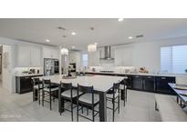 Well-designed kitchen featuring a large island with seating, quartz countertops, and stylish pendant lights at 4507 S 119Th Dr, Avondale, AZ 85323