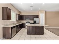 Modern kitchen featuring stainless steel appliances, a granite countertop, and a center island at 1367 S Country Club Dr # 1299, Mesa, AZ 85210