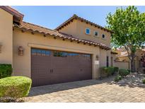 Exterior of charming home featuring a two-car garage, desert landscaping and brick paver driveway at 1508 N Alta Mesa Dr # 120, Mesa, AZ 85205