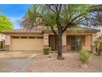 Charming single-story home with a well-manicured front yard and a two-car garage at 2610 E Leiber Ln, Phoenix, AZ 85024