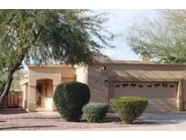Charming single-story home featuring a neutral stucco facade, desert landscaping, and attached two-car garage at 298 N Evergreen St, Chandler, AZ 85225