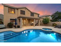 Beautiful backyard pool with a built-in spa and covered patio area perfect for entertaining during sunset at 35206 N 27Th Ave, Phoenix, AZ 85086