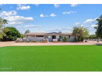 Charming single-story home with a well-maintained lawn and desert landscaping at 4613 E Shangri La Rd --, Phoenix, AZ 85028