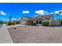 Charming single-story home with gravel landscaping, mature trees, and inviting curb appeal at 6160 E Inglewood St, Mesa, AZ 85205