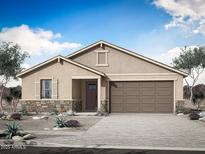 Charming single-story home featuring a two-car garage, stone accents, and a well-manicured front yard at 793 W Riparian Dr, San Tan Valley, AZ 85140