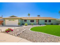 Charming single-story home with verdant lawn, rock garden, and well-maintained landscaping at 810 W Villa Maria Dr, Phoenix, AZ 85023