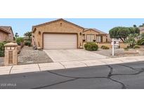 Charming single-story home featuring a two-car garage and well-maintained desert landscaping at 17009 W Eureka Springs Dr, Surprise, AZ 85387