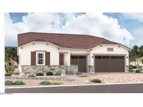 Charming single-story home with a two-car garage, stone accents, desert landscaping, and a clay tile roof at 18177 W Ashley Dr, Goodyear, AZ 85338
