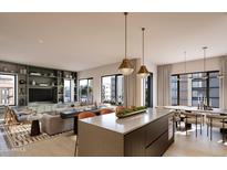 Bright, open-concept living space featuring modern kitchen island, dining area, and stylish built-ins at 19360 N 73Rd St # 1066, Scottsdale, AZ 85255