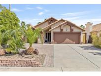 Charming single-story home with desert landscaping, tile roof, and two-car garage at 1962 E Morrow Dr, Phoenix, AZ 85024