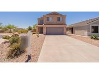 Two-story home featuring a neutral stucco exterior, gray garage door, and low-maintenance landscaping at 23929 W Twilight Trl, Buckeye, AZ 85326