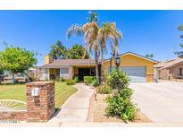 Charming single-Gathering home featuring mature trees and a welcoming walkway to the front door at 3554 W Aire Libre Ave, Phoenix, AZ 85053