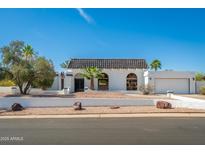 Beautiful home featuring a charming tiled roof, desert landscaping, and a private two-car garage at 3951 E Sequoia Trl, Phoenix, AZ 85044