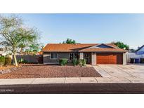 Charming single-level home with desert landscaping, brick accents, and a two-car garage at 919 W Lodge Dr, Tempe, AZ 85283