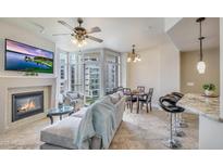 Cozy living room with fireplace, TV, and floor-to-ceiling windows at 140 E Rio Salado Pkwy # 402, Tempe, AZ 85281