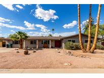 Charming single-story home with desert landscaping and a red front door at 1650 E Gary St, Mesa, AZ 85203
