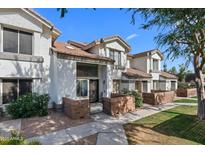 Charming townhome with a well-maintained yard, inviting entrance, and classic desert landscaping at 2201 N Comanche Dr # 1094, Chandler, AZ 85224
