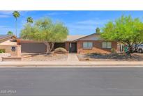 Lovely single-story brick home featuring desert landscaping and a two-car garage at 2524 E Elmwood St, Mesa, AZ 85213