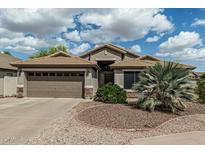 Charming single-story home with a well-manicured front yard, desert landscaping and a two-car garage at 29915 N Maravilla Dr, San Tan Valley, AZ 85143