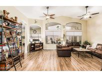 Bright living room with high ceilings, wood floors, and ample natural light at 29915 N Maravilla Dr, San Tan Valley, AZ 85143