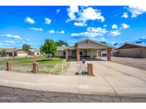 Charming single story home featuring a carport and fenced front yard on a sunny day at 338 W Taro Ln, Phoenix, AZ 85027