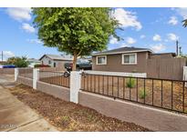 Cozy home featuring a secure front yard with a classic decorative fence at 5519 W Campbell Ave, Phoenix, AZ 85031