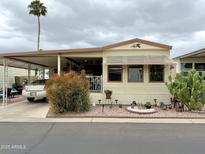 Charming manufactured home with carport, xeriscaping and desert landscaping for low-maintenance living at 7750 E Broadway Rd # 123, Mesa, AZ 85208