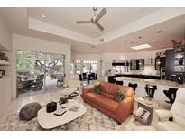 Bright open living space features modern furnishings and seamless transition to outdoor patio and kitchen access at 8230 E Via Del Sol Dr, Scottsdale, AZ 85255