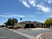 Charming single-story home featuring a two-car garage and desert landscaping at 9621 E Calgary Ave, Sun Lakes, AZ 85248