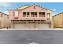 Inviting exterior view of a multi-story home featuring three garage doors and charming balconies at 1350 S Greenfield Rd # 1125, Mesa, AZ 85206