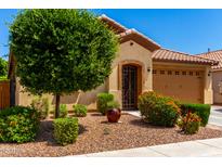 Charming single-story home featuring a well-maintained front yard and a two-car garage at 1361 N Claiborne --, Mesa, AZ 85205