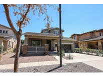 Charming two-story home featuring a welcoming front porch and a two-car garage at 15365 W Valentine St, Surprise, AZ 85379