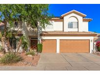 Charming two-story home featuring a well-manicured lawn, desert landscaping, and a two-car garage at 15829 S 13Th Pl, Phoenix, AZ 85048