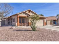 Charming single-story home featuring a low-maintenance desert landscape and a two-car garage at 21181 N 80Th Ln, Peoria, AZ 85382