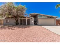 Charming single-story home featuring a stylish exterior with unique architectural details at 3013 W Port Au Prince Ln, Phoenix, AZ 85053
