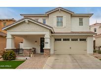 Charming two-story home featuring a covered porch, a two car garage and a landscaped front yard at 3308 E Jasper Dr, Gilbert, AZ 85296