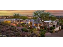 Stunning contemporary home with a desert landscape and mountain views at sunset at 37221 N Holiday Ln, Carefree, AZ 85377