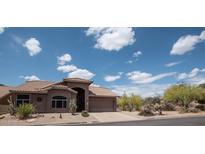 Charming single-story home featuring desert landscaping and a tile roof under a bright blue sky at 4970 S Desert Willow Dr, Gold Canyon, AZ 85118