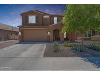 Charming two-story home featuring a two-car garage, landscaped front yard, and inviting entryway at 5239 W Leodra Ln, Laveen, AZ 85339