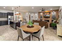 Open-concept space integrates the kitchen, dining area, and living room with cozy fireplace at 5649 E Desert Forest Trl, Cave Creek, AZ 85331